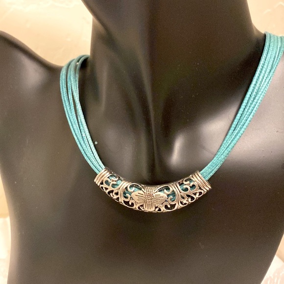 Jewelry - Necklace. Teal cord, 5 strands with Silver tone metal floral design slide.